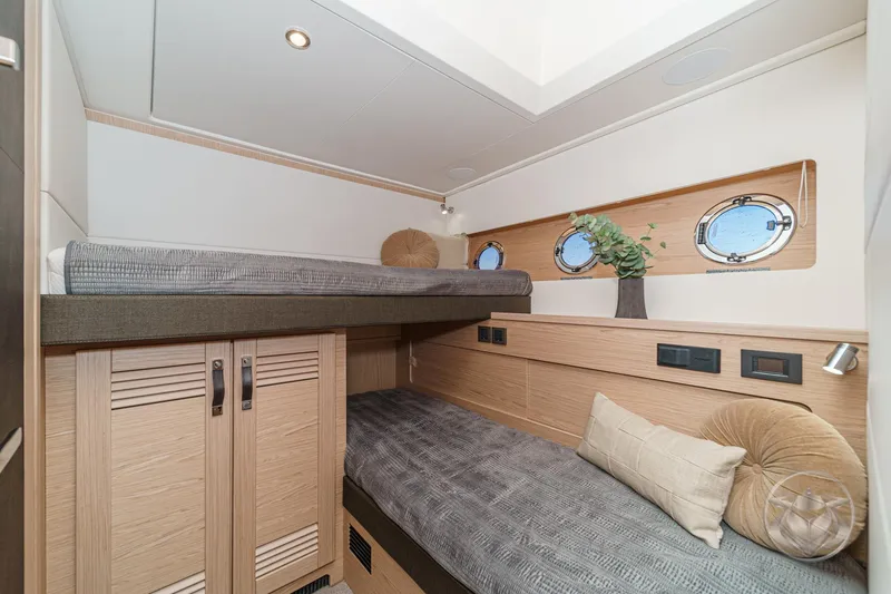 Slide: The Image of Washing machine in 2026 Beneteau Swift Trawler 54, integrated into wooden cabinetry. - 39