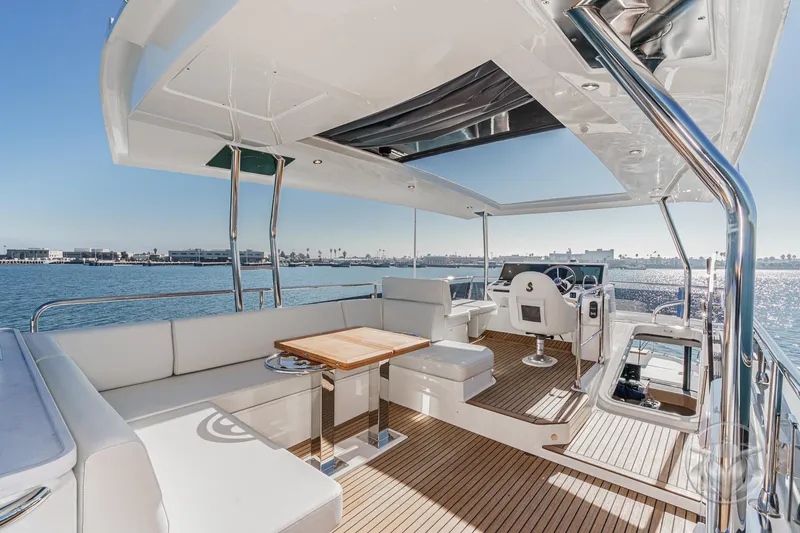 Slide: The Image of Luxurious seating area on 2026 Beneteau Swift Trawler 54 with wooden table and ocean view. - 42