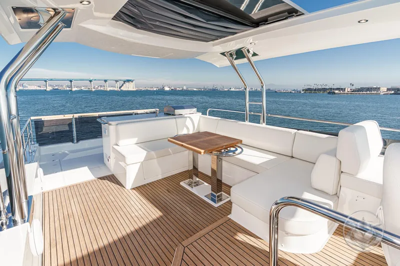 Slide: The Image of Flybridge of 2026 Beneteau Swift Trawler 54 with modern navigation equipment and seating. - 44