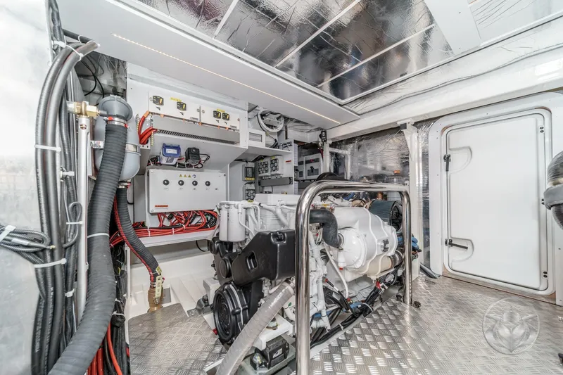 Slide: The Image of Engine room of 2026 Beneteau Swift Trawler 54, featuring modern equipment and metallic finishes. - 50