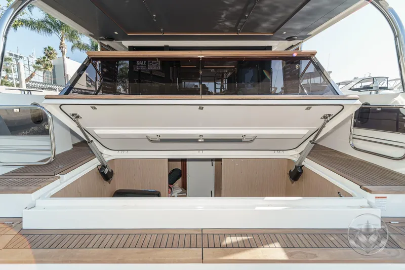 Slide: The Image of 2026 Beneteau Swift Trawler 54 cruising on open water, showcasing sleek design and luxury. - 56