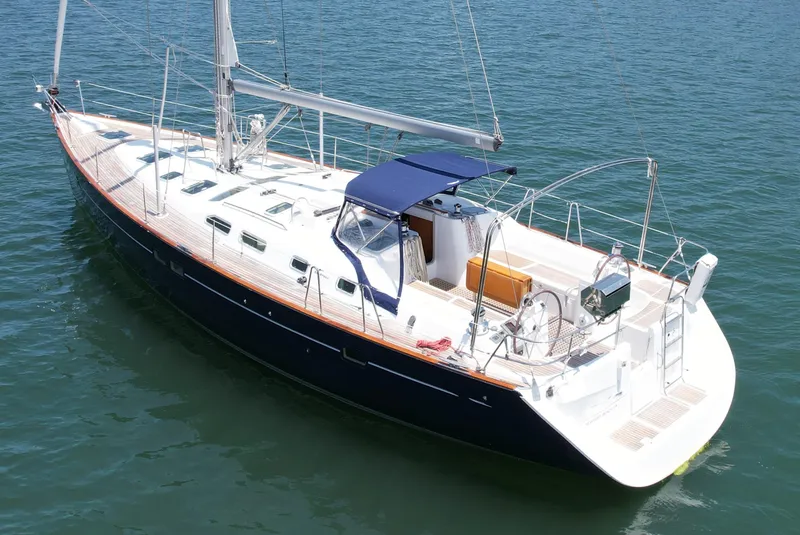 Slide: The Image of 2004 Beneteau Oceanis Clipper 473 sailboat on calm water, featuring sleek design and spacious deck. - 1