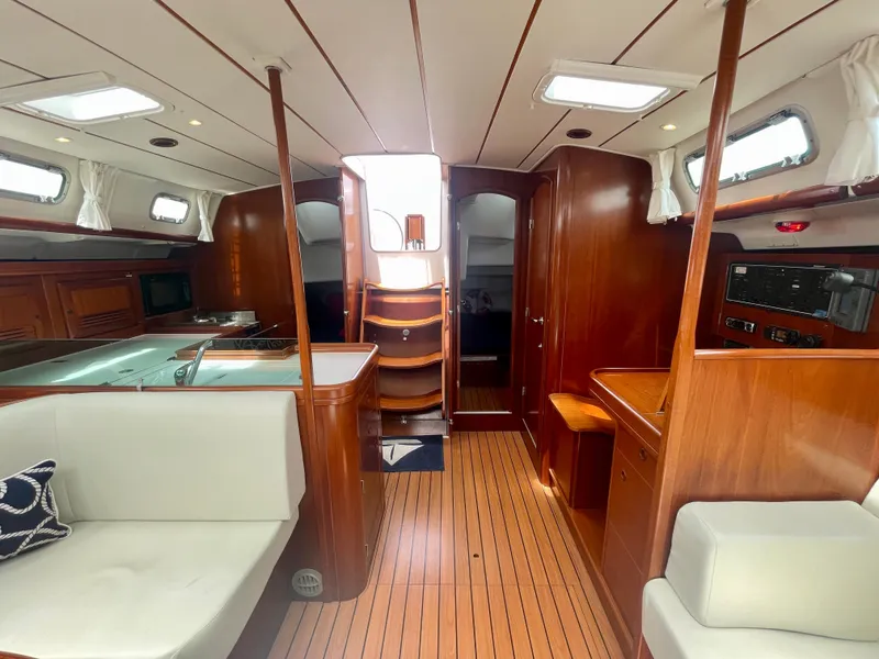 Slide: The Image of Interior of 2004 Beneteau Oceanis Clipper 473 yacht with wood finish and seating area. - 10