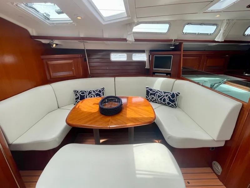Slide: The Image of Luxurious interior of 2004 Beneteau Oceanis Clipper 473 yacht with elegant seating and wooden table. - 13