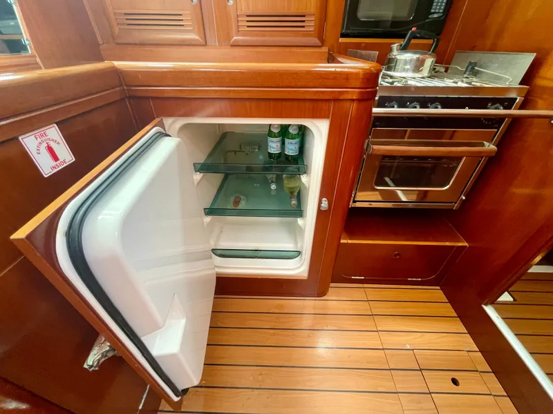 Slide: The Image of Interior of 2004 Beneteau Oceanis Clipper 473 yacht kitchen with open fridge and stove. - 21
