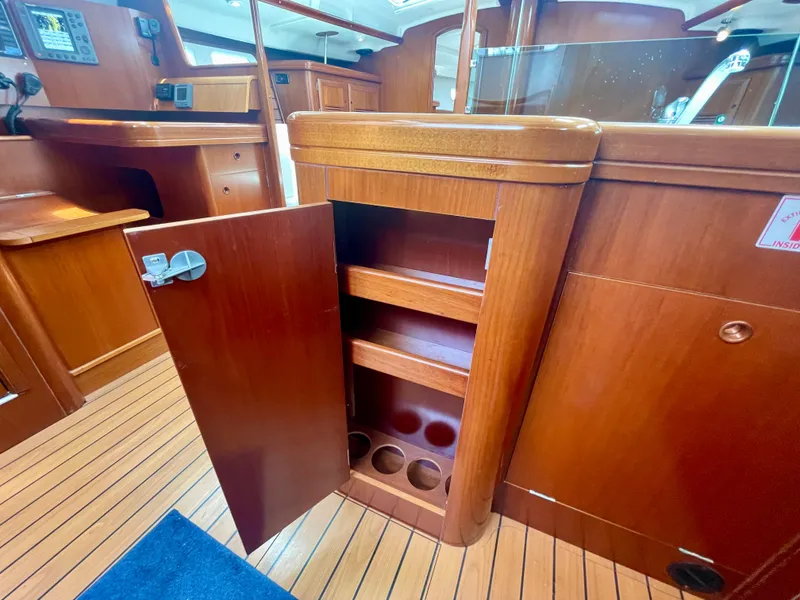 Slide: The Image of Interior of 2004 Beneteau Oceanis Clipper 473 yacht with open wooden cabinet and shelves. - 23