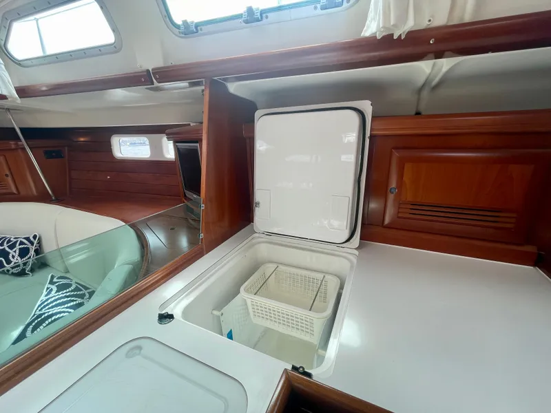 Slide: The Image of Interior of 2004 Beneteau Oceanis Clipper 473 yacht, featuring a sleek kitchen area. - 26
