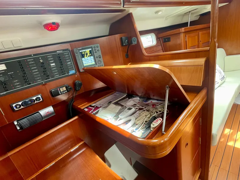 Slide: The Image of Navigation station of 2004 Beneteau Oceanis Clipper 473 with control panel and storage. - 30