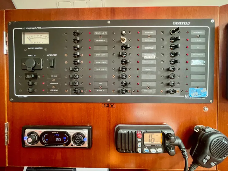 Slide: The Image of Control panel of a 2004 Beneteau Oceanis Clipper 473 yacht, featuring various switches and gauges. - 31