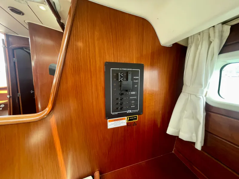 Slide: The Image of Interior of 2004 Beneteau Oceanis Clipper 473 yacht with control panel and wooden finish. - 36