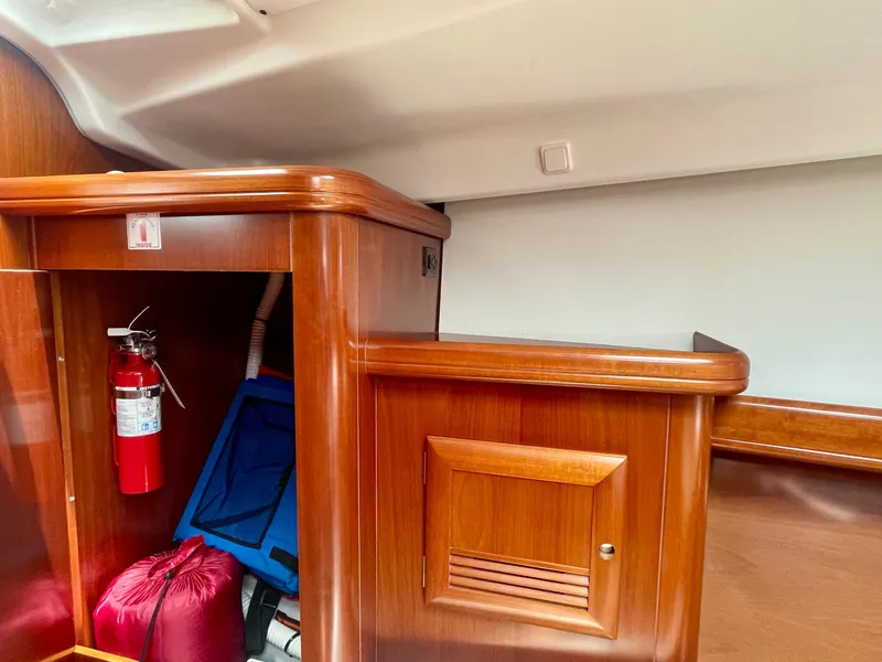 Slide: The Image of Interior of 2004 Beneteau Oceanis Clipper 473 yacht with wooden cabinetry and safety equipment. - 39