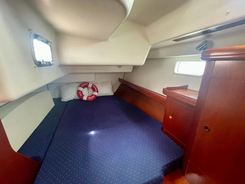 Slide: The Image of Cozy cabin interior of 2004 Beneteau Oceanis Clipper 473 with blue bedding and wooden accents. - 43