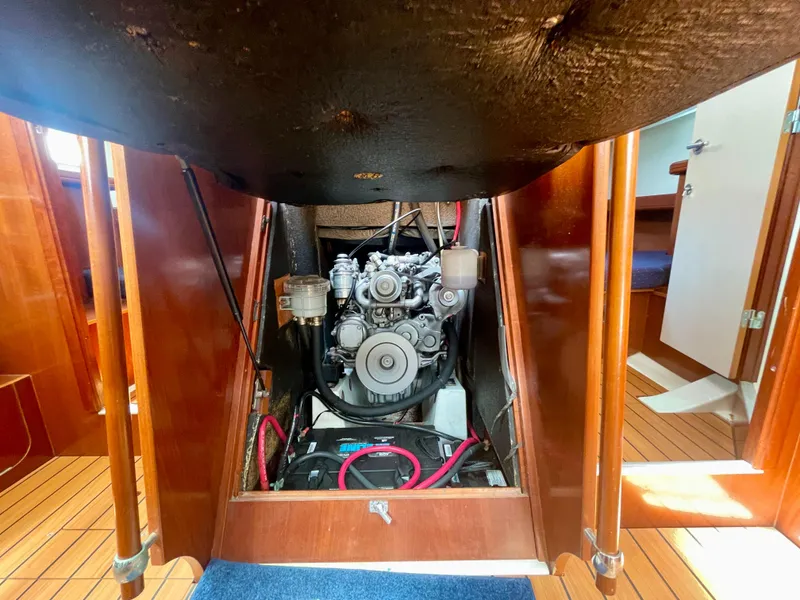 Slide: The Image of Engine compartment of 2004 Beneteau Oceanis Clipper 473 sailboat, showcasing mechanical components. - 49