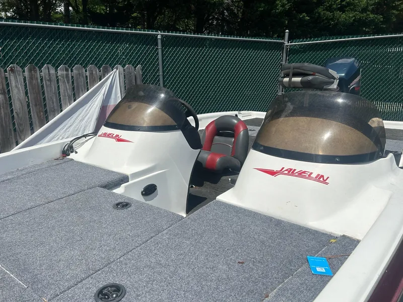 Slide: The Image of 2000 Javelin 20 Renegade boat with dual consoles and red accents, parked outdoors. - 3