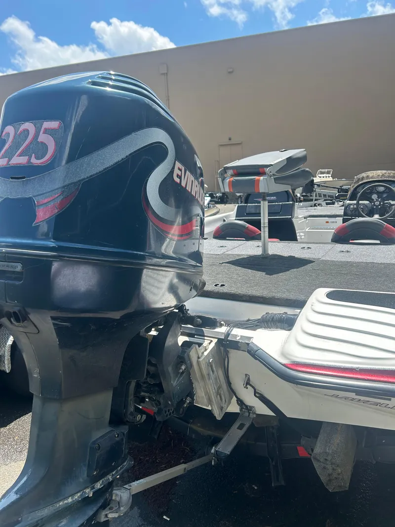 Slide: The Image of 2000 Javelin 20 Renegade boat with Evinrude 225 outboard motor, parked outdoors. - 6