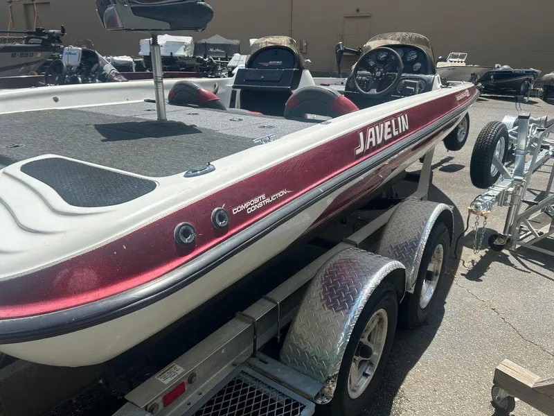 Slide: The Image of 2000 Javelin 20 Renegade boat on trailer, red and white design, parked outdoors. - 9