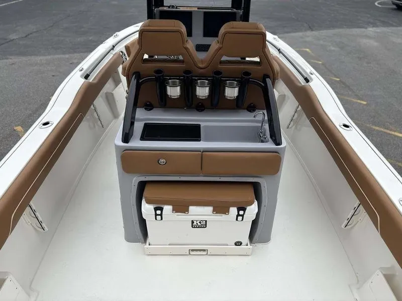 Slide: The Image of 2025 Key West 239FSR boat interior with seating, sink, and cooler. - 11