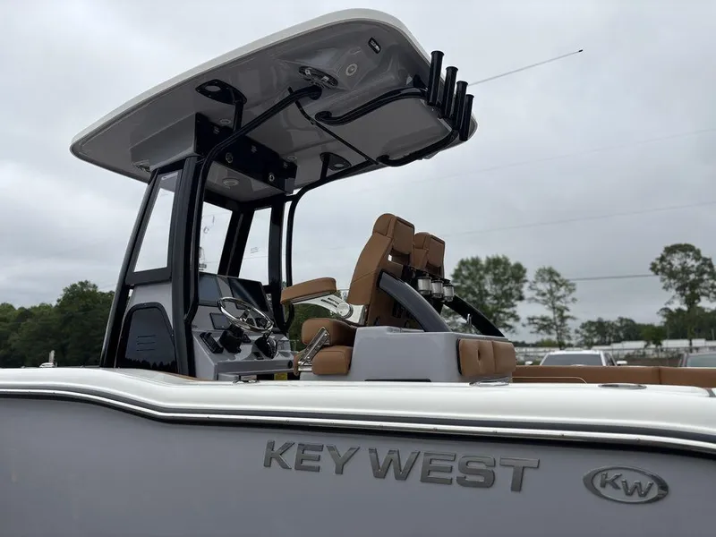 Slide: The Image of 2025 Key West 239FSR boat with sleek design and modern features, docked outdoors. - 17