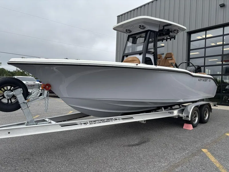 Slide: The Image of 2025 Key West 239FSR boat on trailer, parked outside a building. - 19