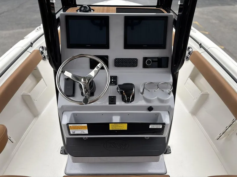 Slide: The Image of 2025 Key West 239FSR boat console with dual screens and steering wheel. - 2