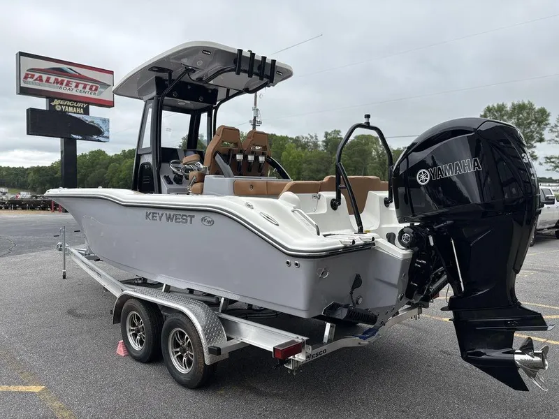 Slide: The Image of 2025 Key West 239FSR boat on trailer with Yamaha outboard motor, parked outdoors. - 21