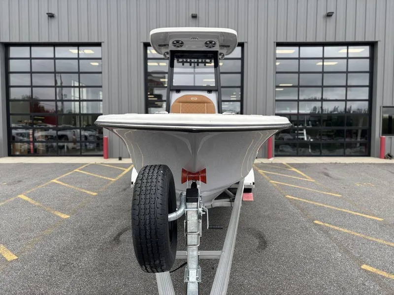 Slide: The Image of 2025 Key West 239FSR boat on trailer, parked outside a modern building. - 22