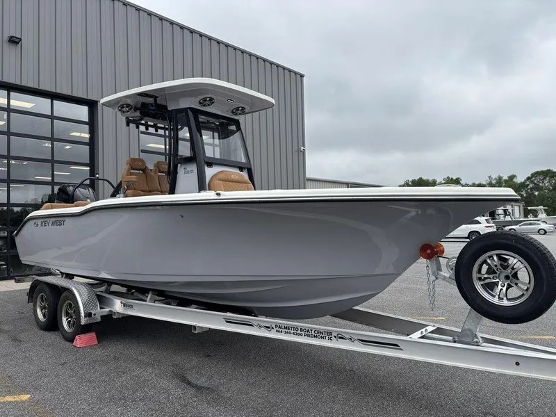 Slide: The Image of 2025 Key West 239FSR boat on trailer outside a building. - 23