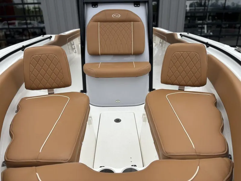 Slide: The Image of 2025 Key West 239FSR boat interior with tan cushioned seating and diamond stitching. - 25