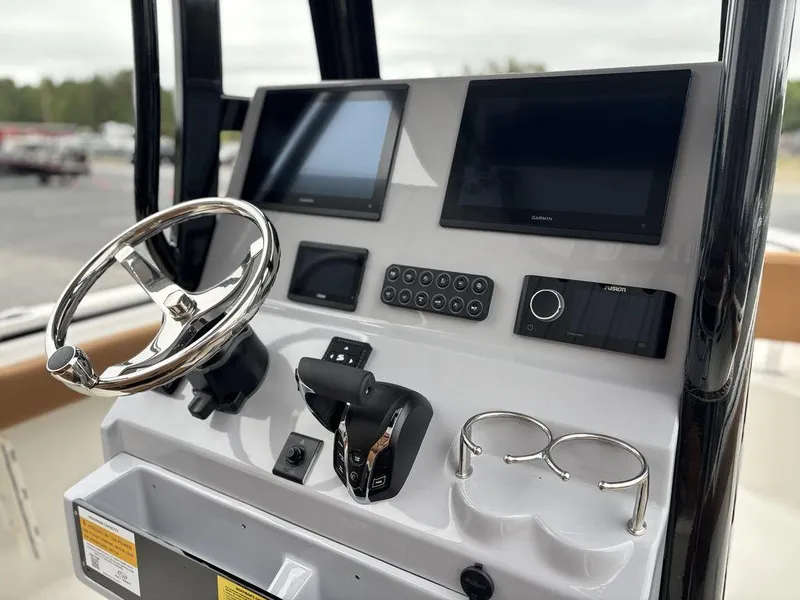 Slide: The Image of 2025 Key West 239FSR boat dashboard with dual screens and steering wheel. - 3