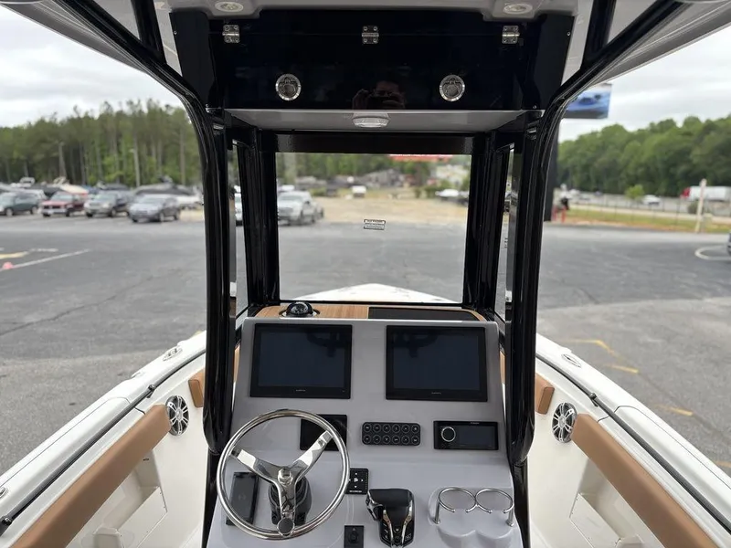 Slide: The Image of 2025 Key West 239FSR boat dashboard with dual screens and steering wheel. - 4