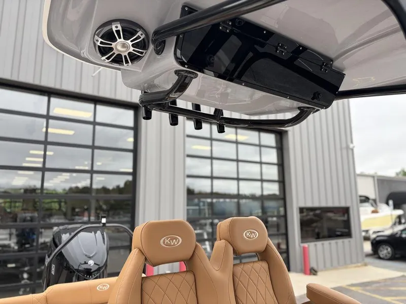 Slide: The Image of 2025 Key West 239FSR boat interior with tan seats and overhead speaker system. - 6