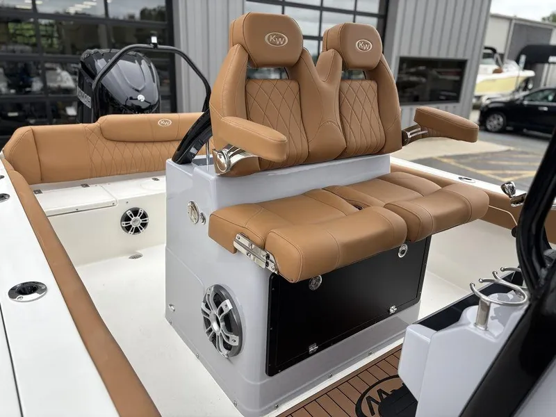 Slide: The Image of 2025 Key West 239FSR boat interior with tan leather seats and modern design. - 8