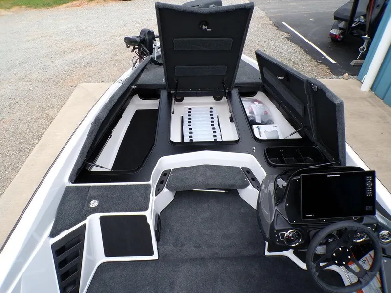 Slide: The Image of 2025 Skeeter ZXR20 boat interior with open storage compartments and modern dashboard. - 10