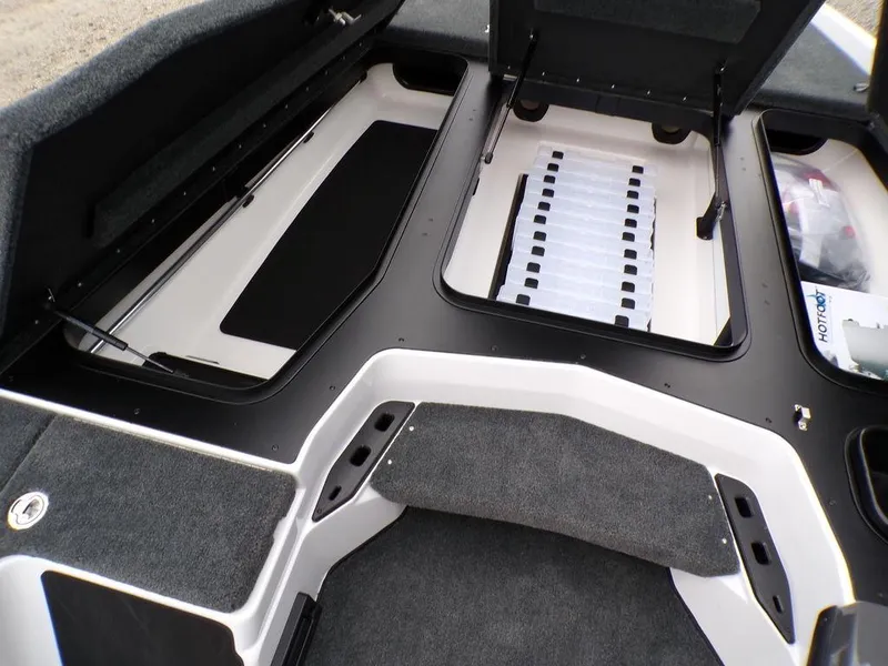 Slide: The Image of 2025 Skeeter ZXR20 boat interior storage compartments with open lids, showcasing organized space. - 11