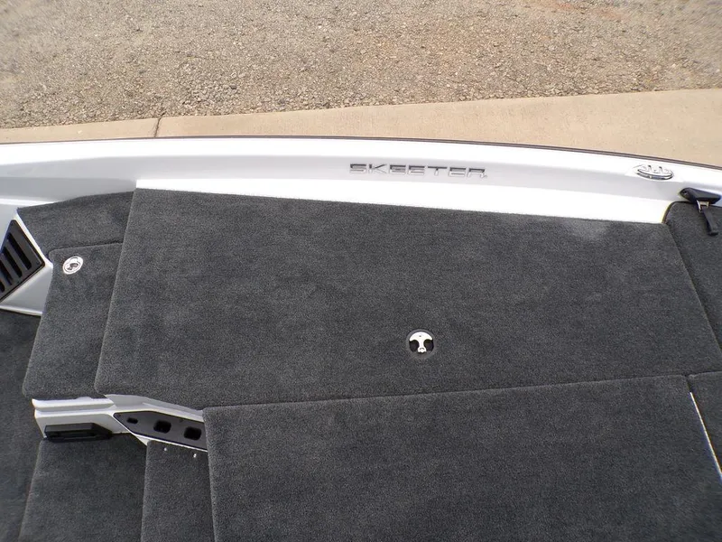 Slide: The Image of 2025 Skeeter ZXR20 boat deck with gray carpet and logo detail. - 12