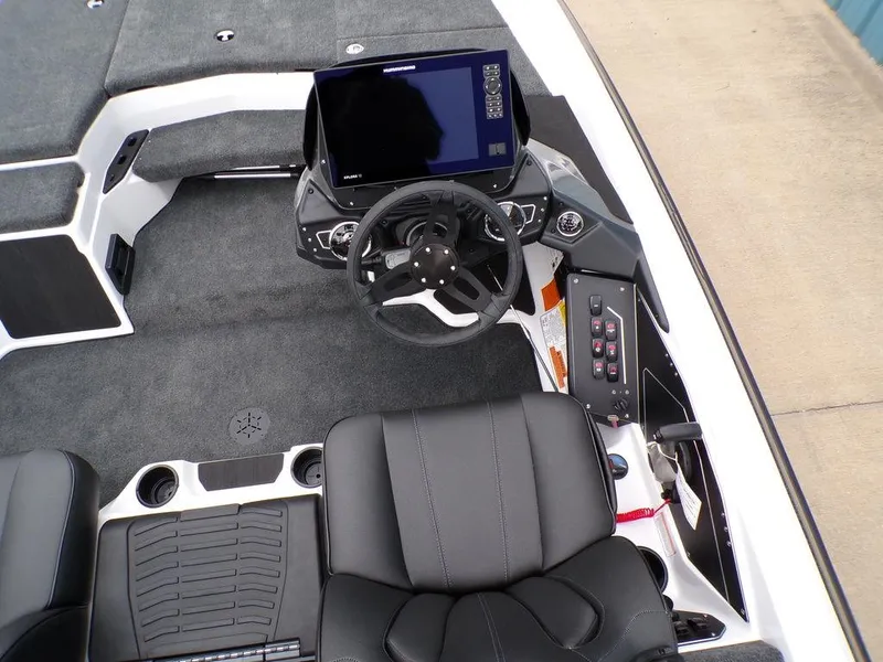 Slide: The Image of 2025 Skeeter ZXR20 boat interior with steering wheel, control panel, and seating. - 5