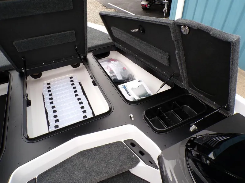 Slide: The Image of 2025 Skeeter ZXR20 boat storage compartments open, showcasing organized interior space. - 8