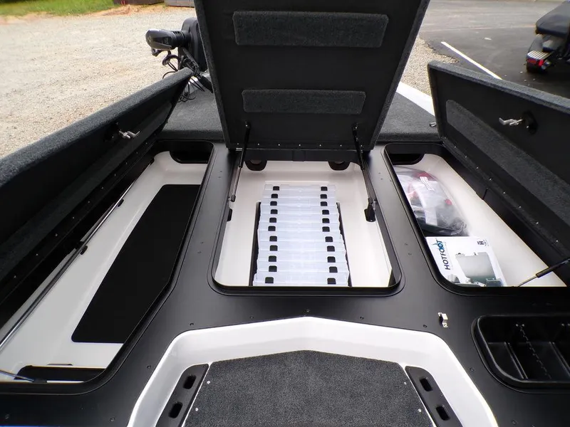 Slide: The Image of 2025 Skeeter ZXR20 boat storage compartments with open lids, showcasing organized interior space. - 9
