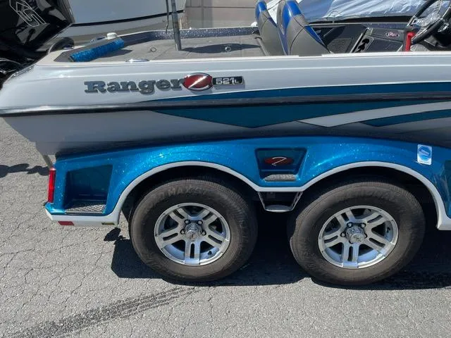 Slide: The Image of 2018 Ranger Z521L boat on a trailer with dual wheels, blue and gray design. - 10