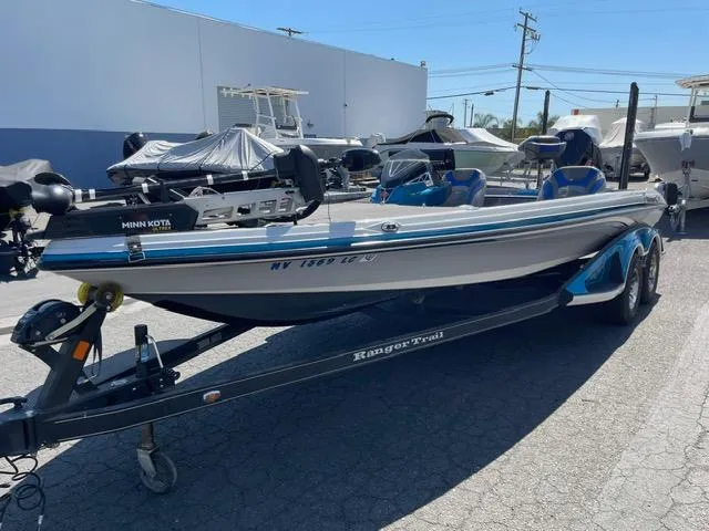 Slide: The Image of 2018 Ranger Z521L boat on trailer, parked outdoors, featuring Minn Kota trolling motor. - 2