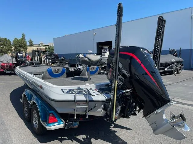 Slide: The Image of 2018 Ranger Z521L boat with powerful outboard motor, parked outdoors on a sunny day. - 4
