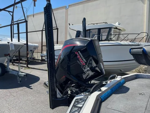 Slide: The Image of 2018 Ranger Z521L boat with powerful outboard motor in a marina setting. - 5