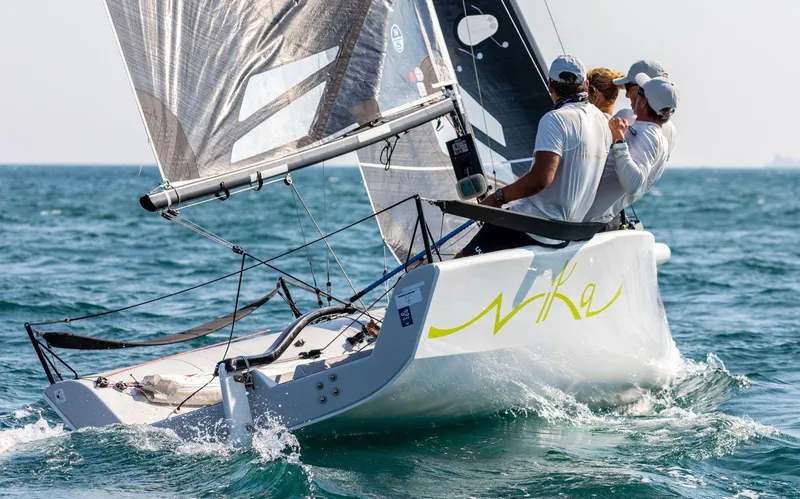 Slide: The Image of Sailing on a 2016 Melges 20 boat with crew, navigating clear blue waters. - 11