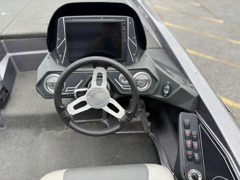 Slide: The Image of 2017 Skeeter ZX250 boat dashboard with steering wheel and control panel. - 11