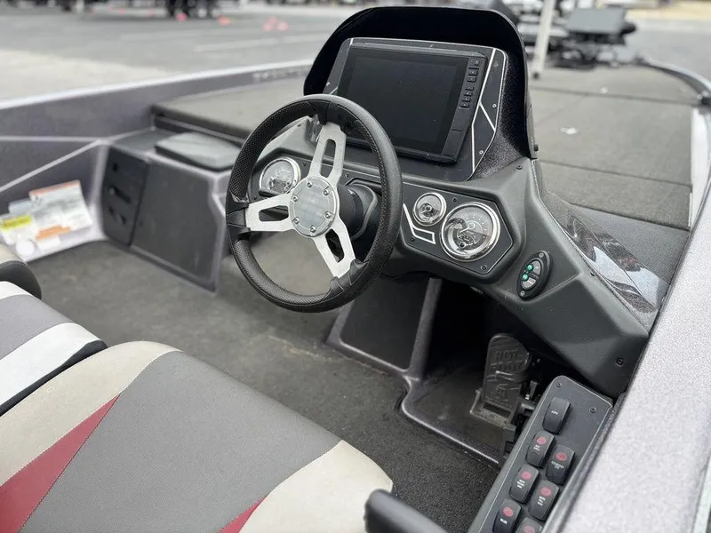Slide: The Image of 2017 Skeeter ZX250 boat interior with steering wheel and dashboard controls. - 12