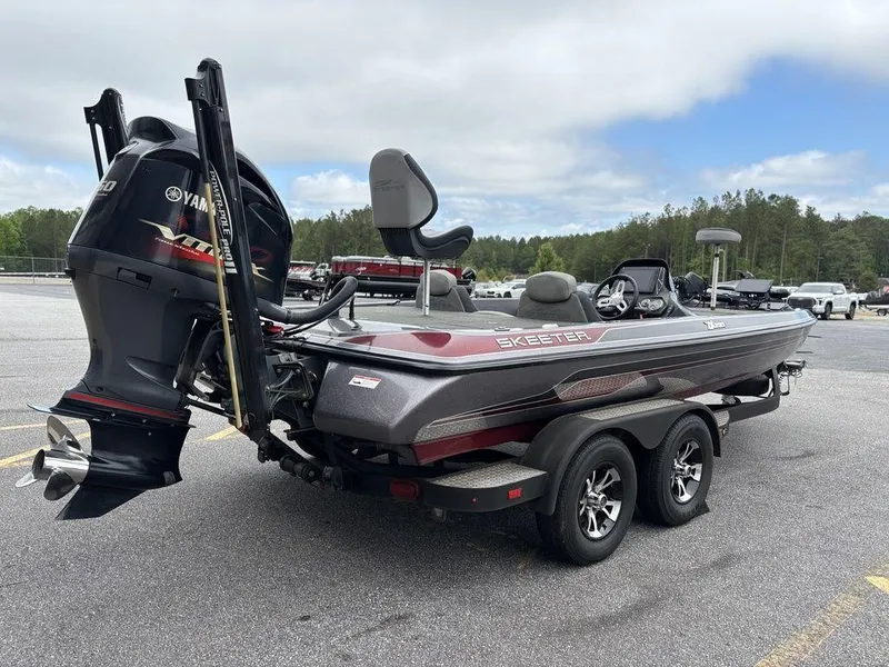 Slide: The Image of 2017 Skeeter ZX250 boat with Yamaha engine on a trailer in a parking lot. - 3