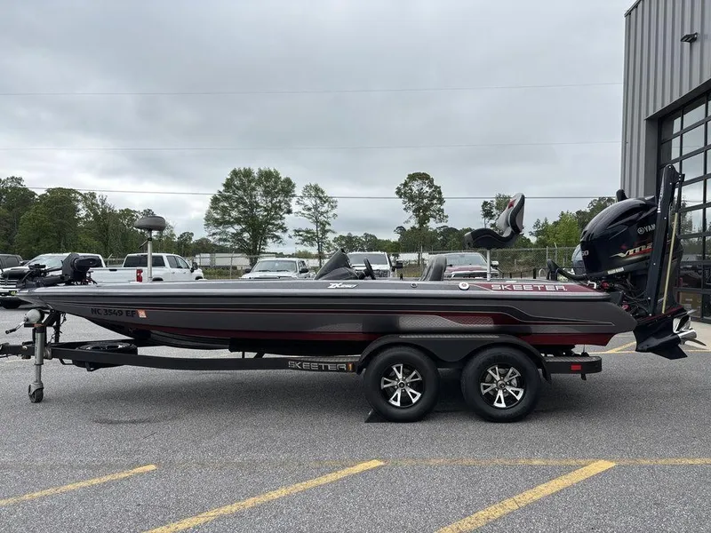 Slide: The Image of 2017 Skeeter ZX250 boat on trailer in parking lot, overcast sky. - 6