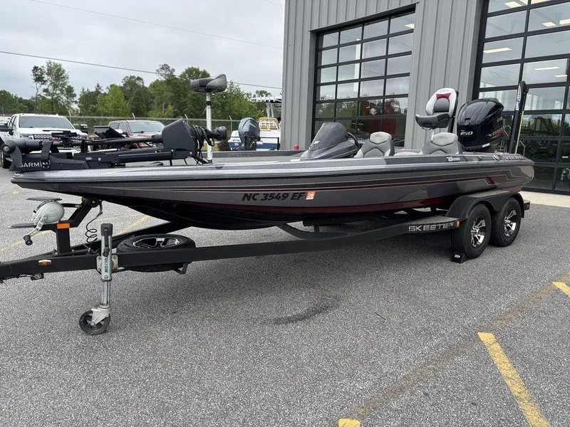 Slide: The Image of 2017 Skeeter ZX250 boat on trailer, parked outside a building. - 9