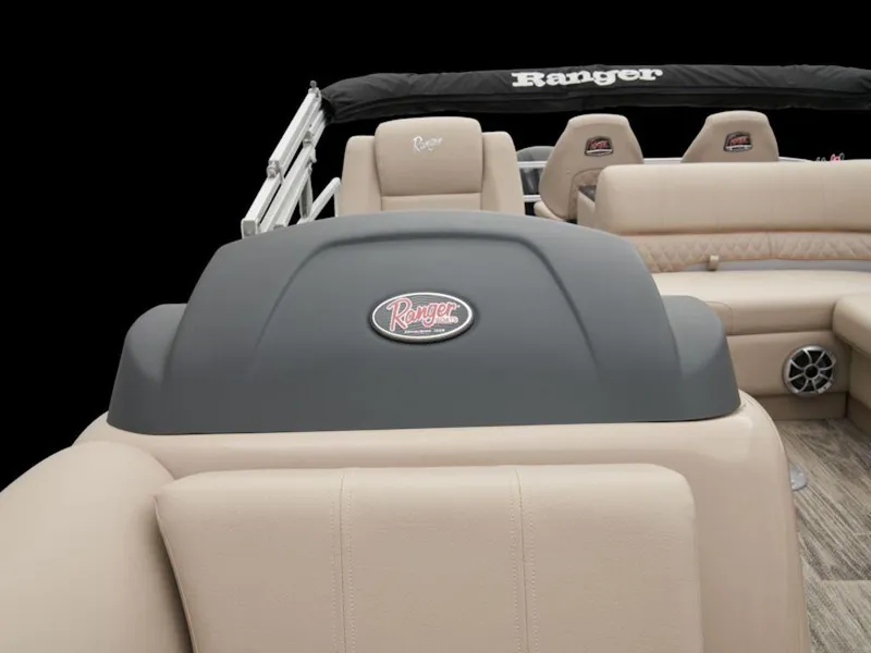 Slide: The Image of 2024 Ranger 220FC boat interior with beige seating and branded logo. - 5