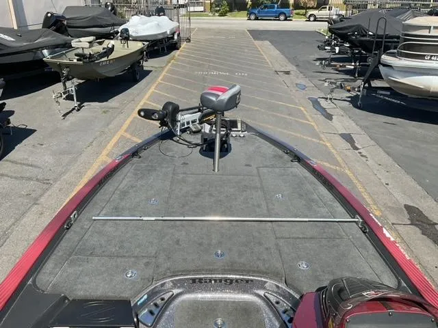 Slide: The Image of 2016 Ranger Z521 Comanche boat on trailer in parking lot, surrounded by other boats. - 9